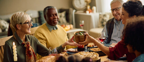 People sharing a holiday meal at a dining table.