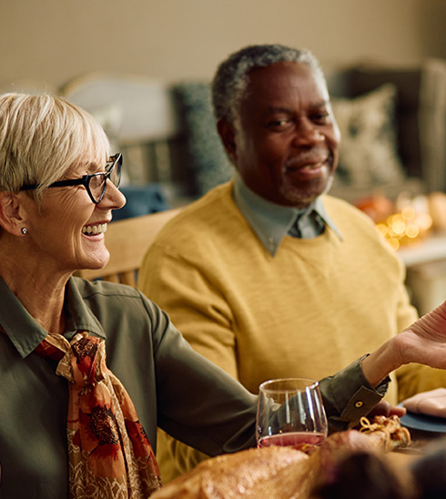 People sharing a holiday meal at a dining table.