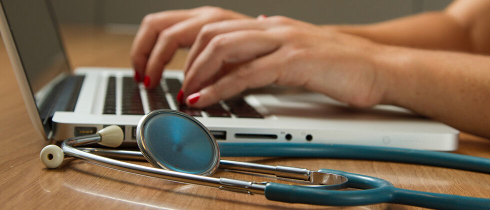 Hands typing on a keyboard, representing digital innovation.