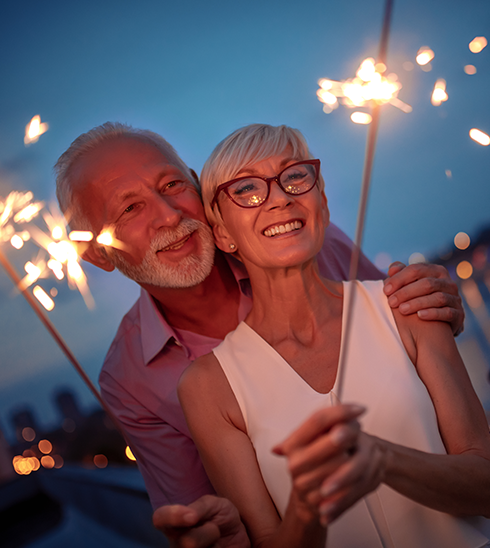 Person holding a sparkler outdoors, symbolizing independence.