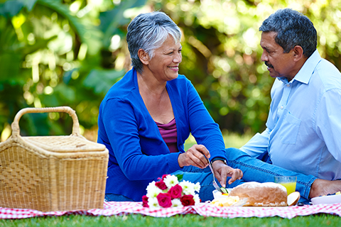 People enjoying a picnic outdoors, highlighting connection and joy.