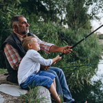 Person fishing by a lake, symbolizing calm, independent living.